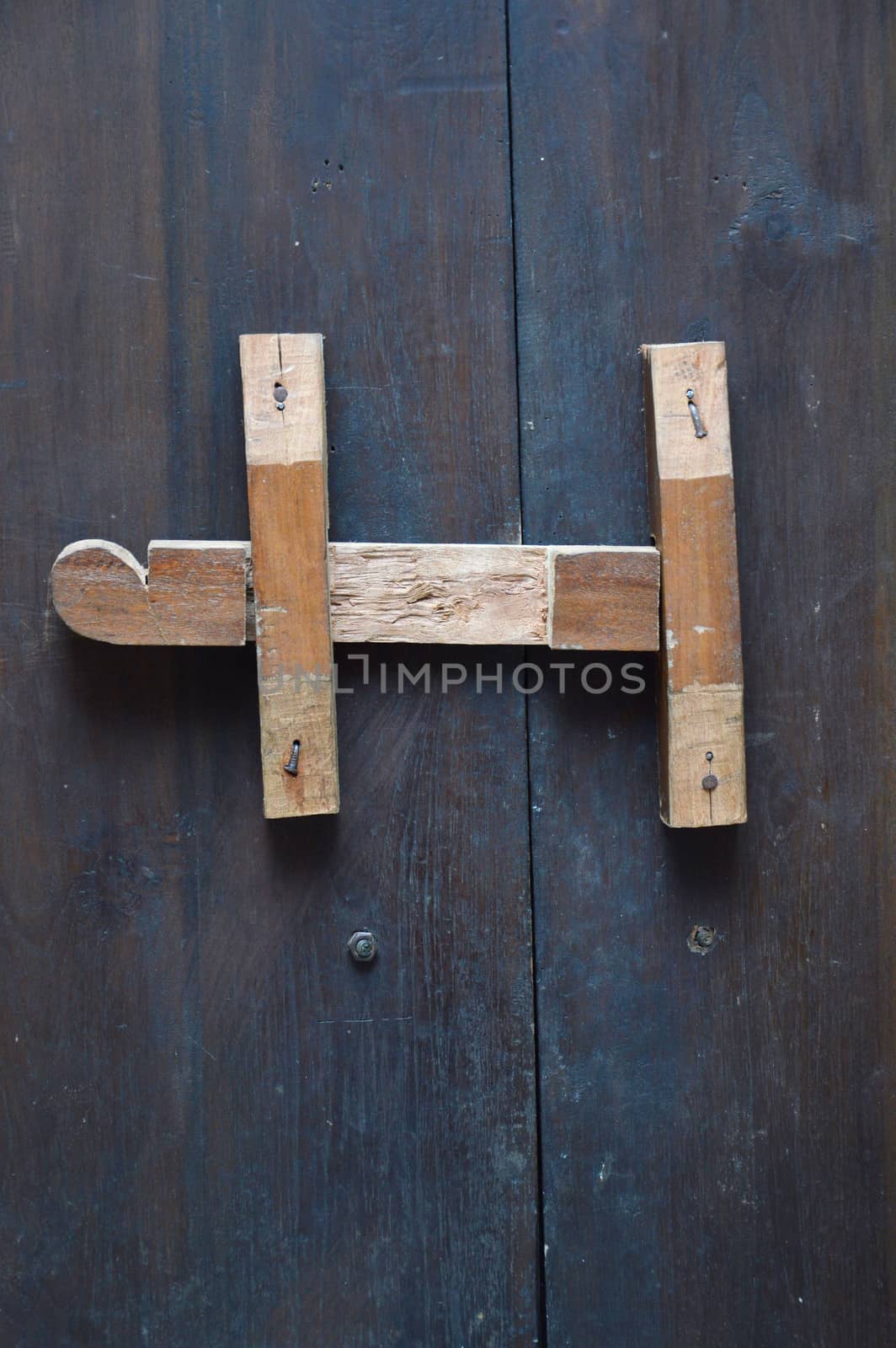 wooden lock bar on the wooden door