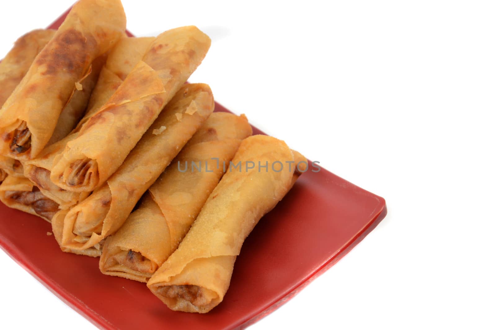 lumpia Semarang or Spring Rolls containing bamboo shoots and chicken on red plate at white background 