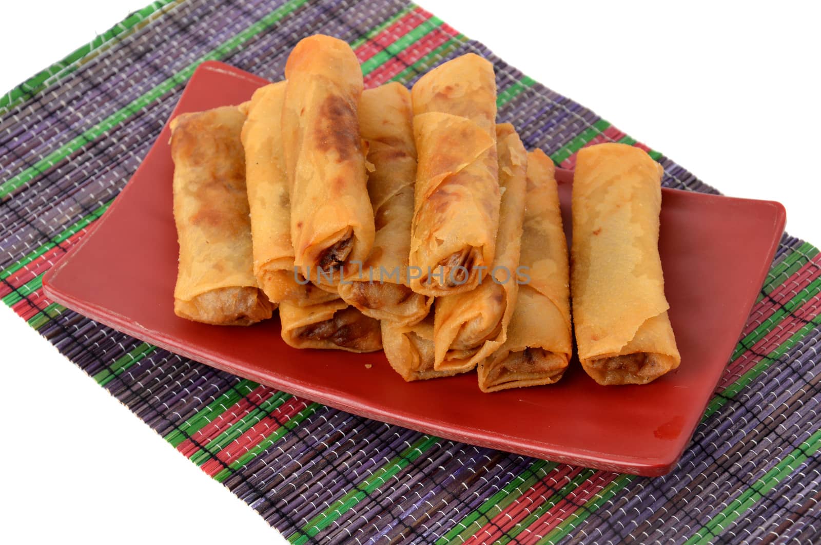 lumpia Semarang or Spring Rolls containing bamboo shoots and chicken on red plate at white background 