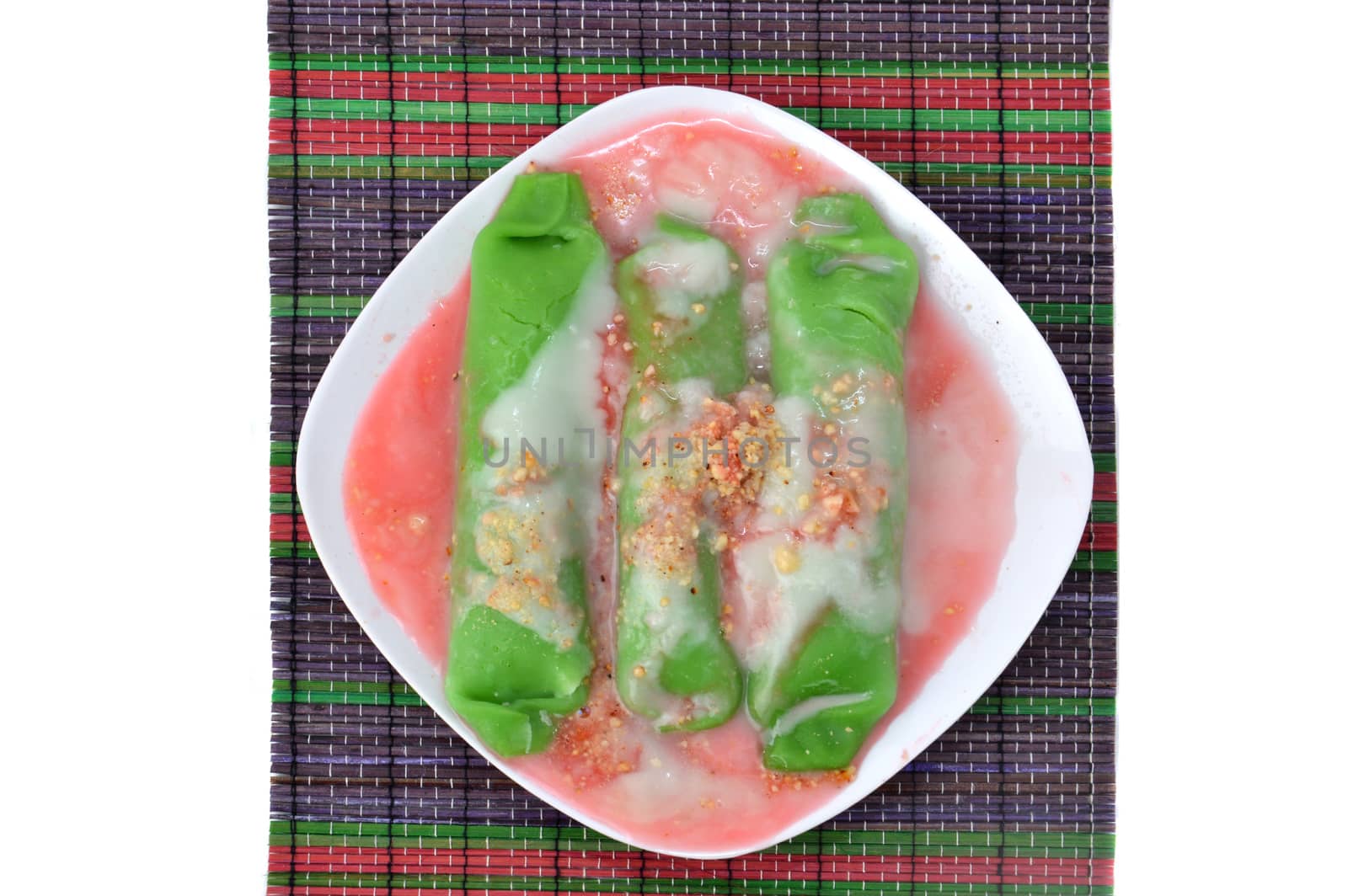 pisang ijo ice or green banana ice a tradisonal snack foods from ethnic Bugis or Makassar made of ripe banana pancakes wrapped in pandan leaf extract gravy with fla, syrup,milk and peanut powder