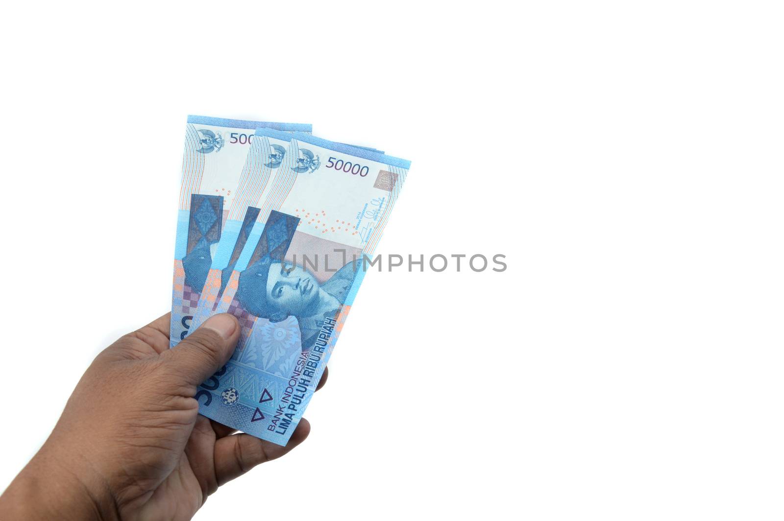 male hand hold fifty thousand rupiah Indonesian paper money on white background
