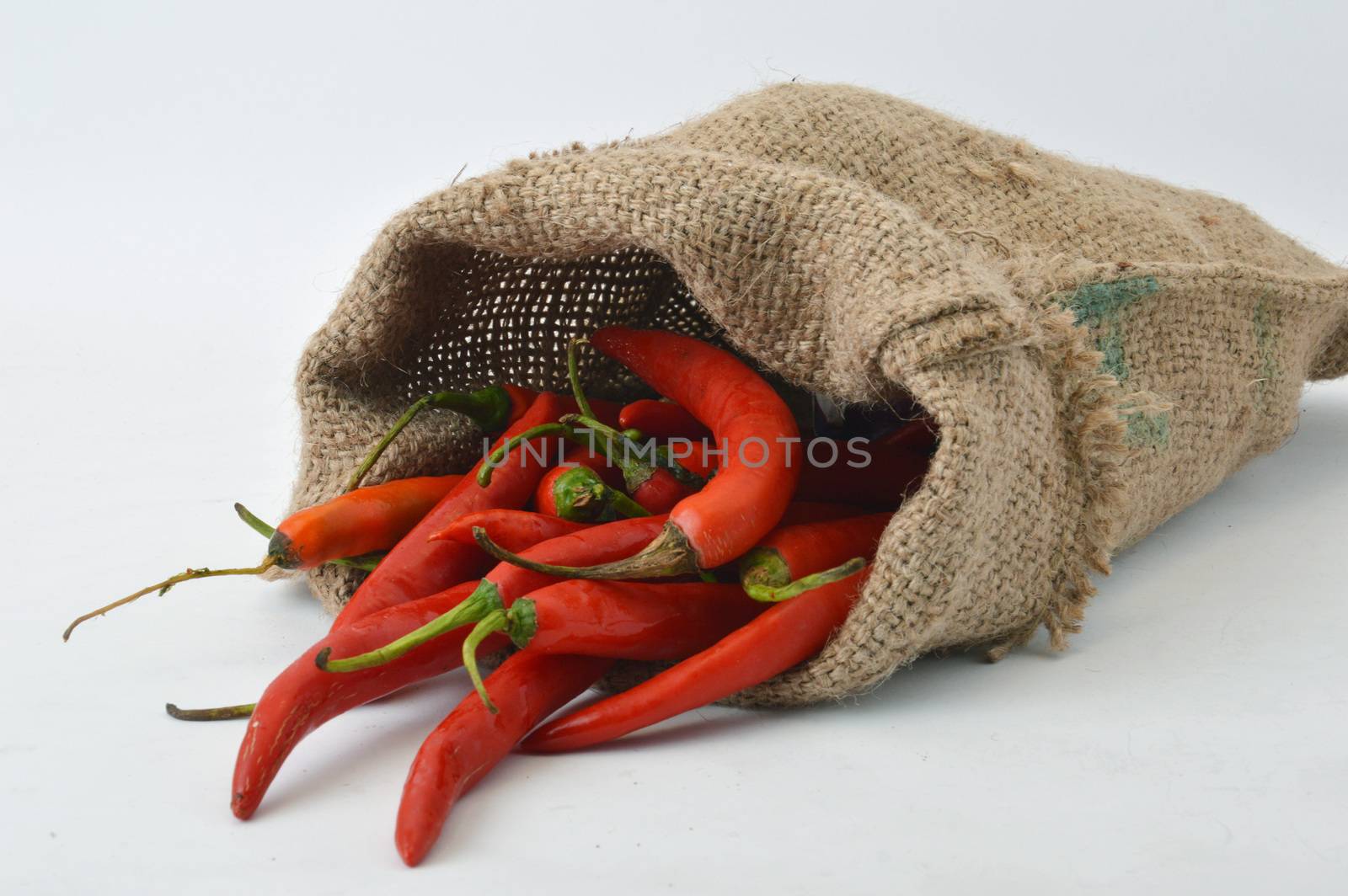 big chili red in a burlap sack on white background