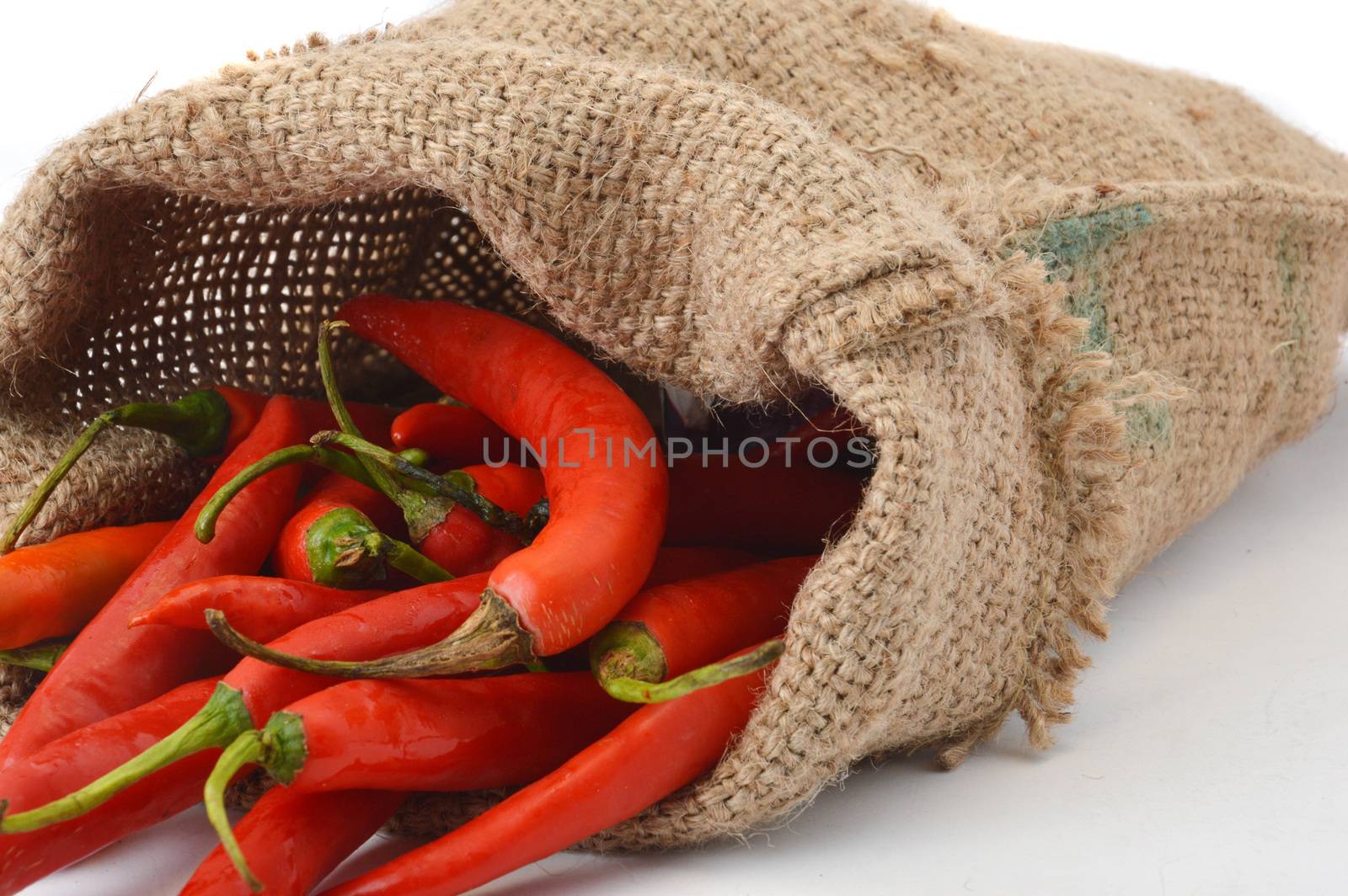 big chili red in a burlap sack on white background