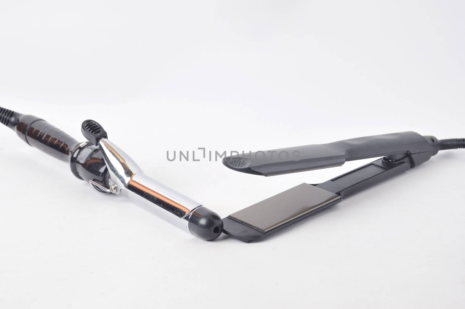 hair straightening tool and iron curly on white background