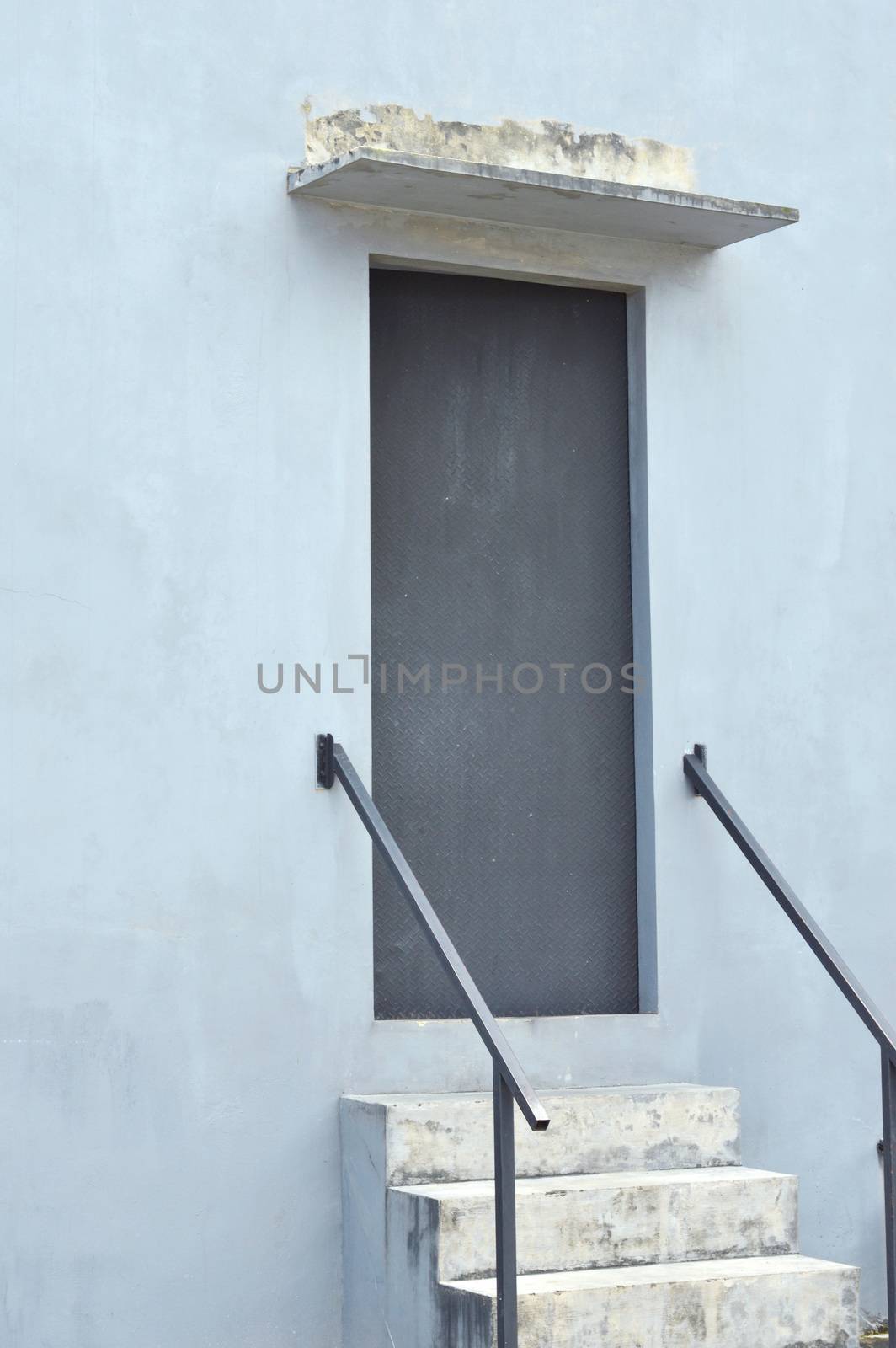 iron door with stairs at the rear of the building