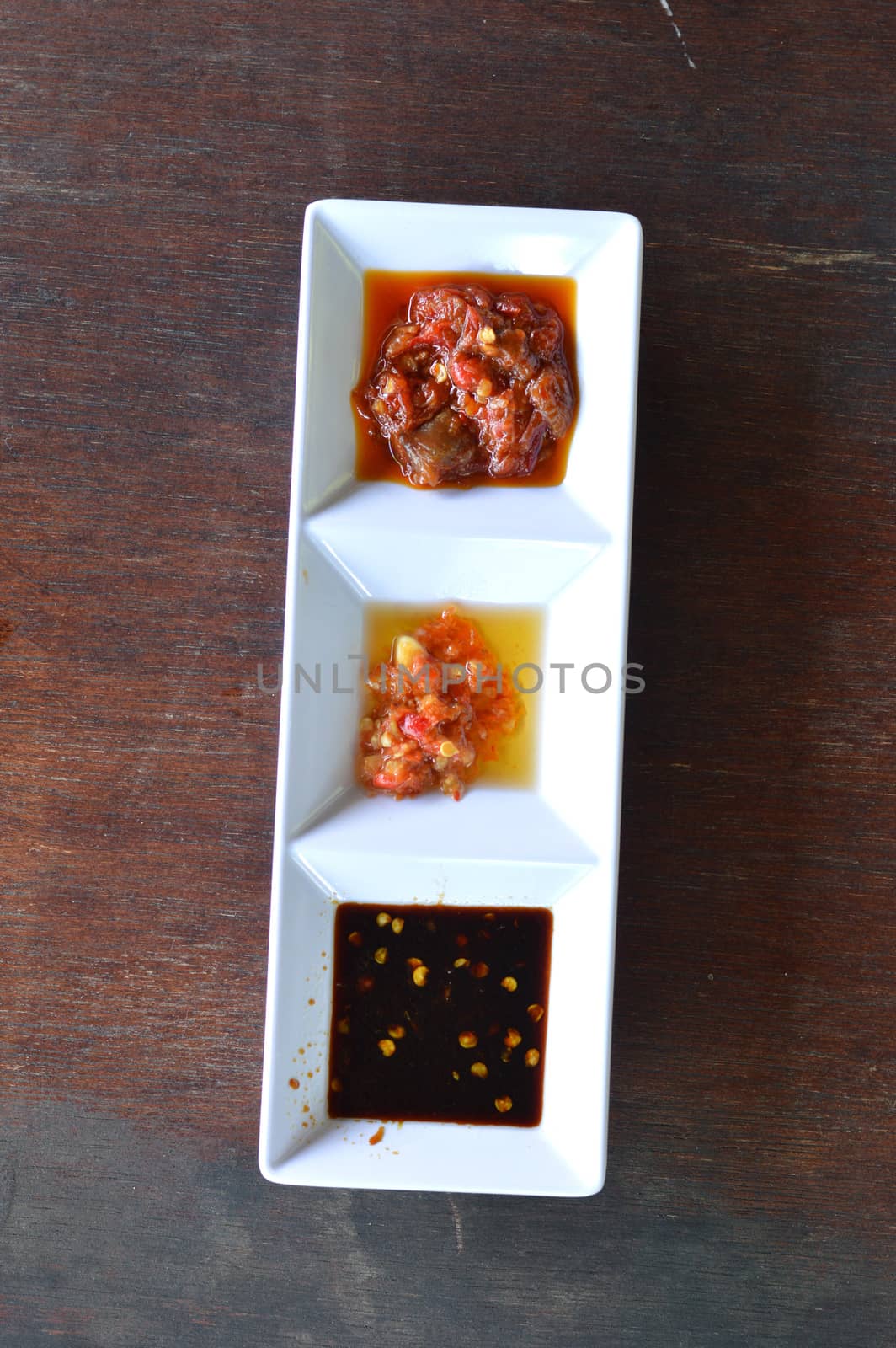 three types of chili sauce in white bowl