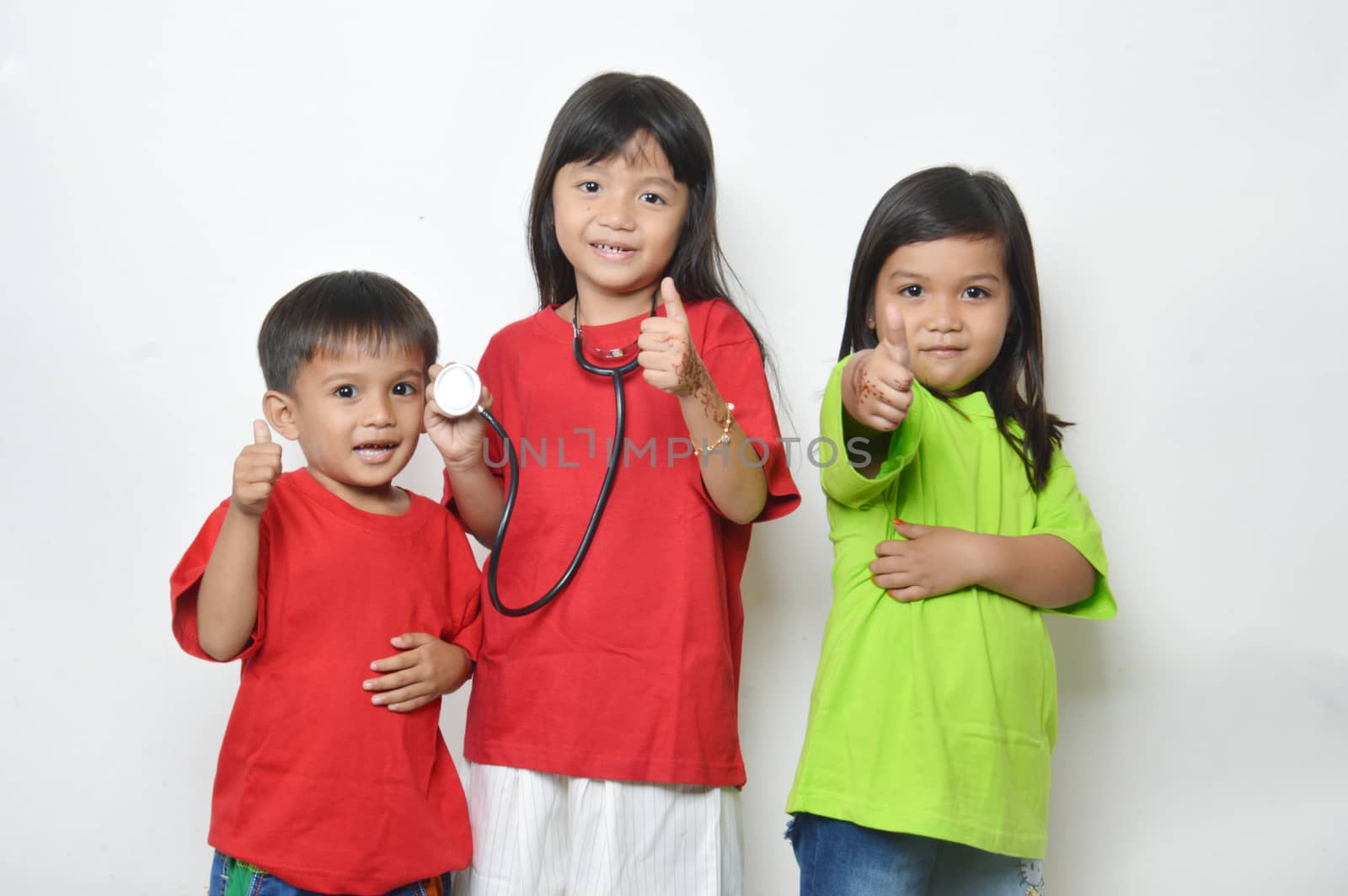 three asian kids a stethoscope