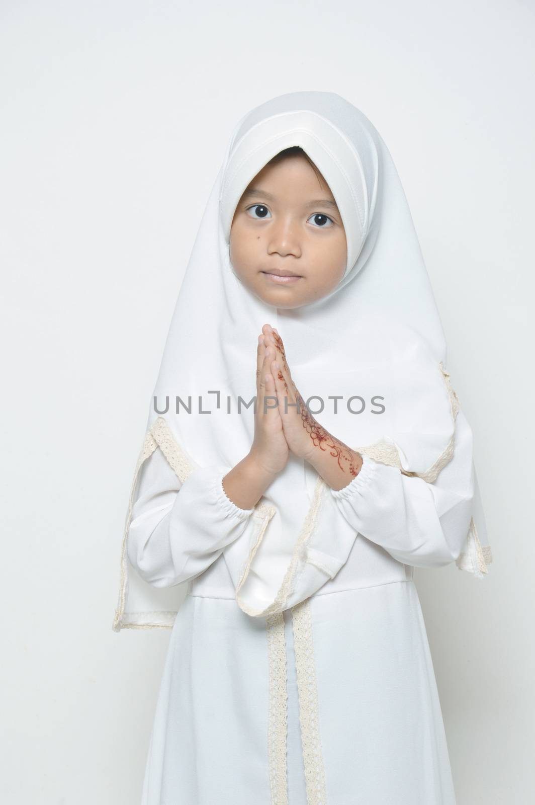 Moslem Asian little girl dressed with hijab in white