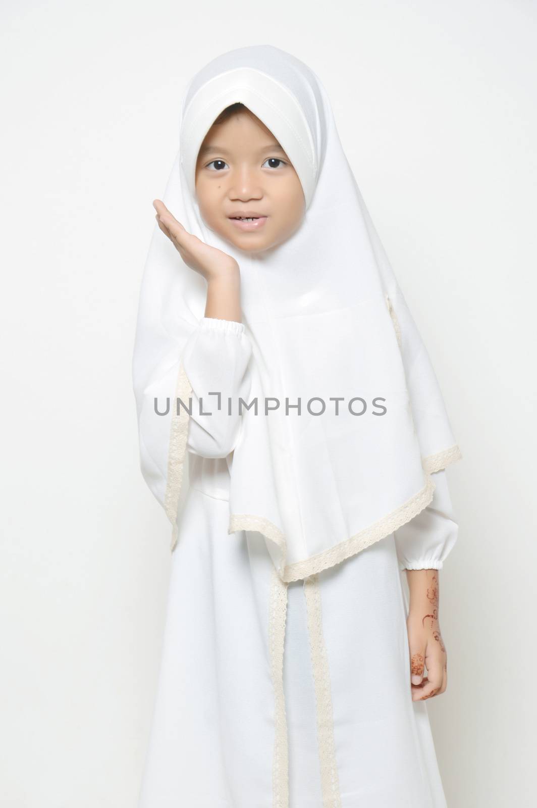 Moslem Asian little girl dressed with hijab in white