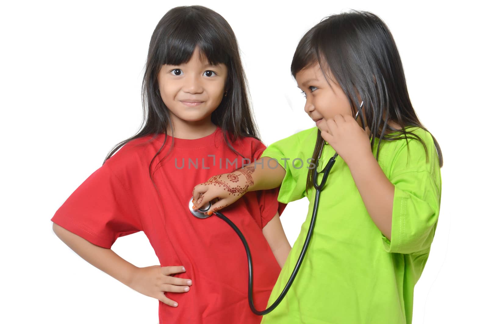 two asian little girl playing with a stethoscope