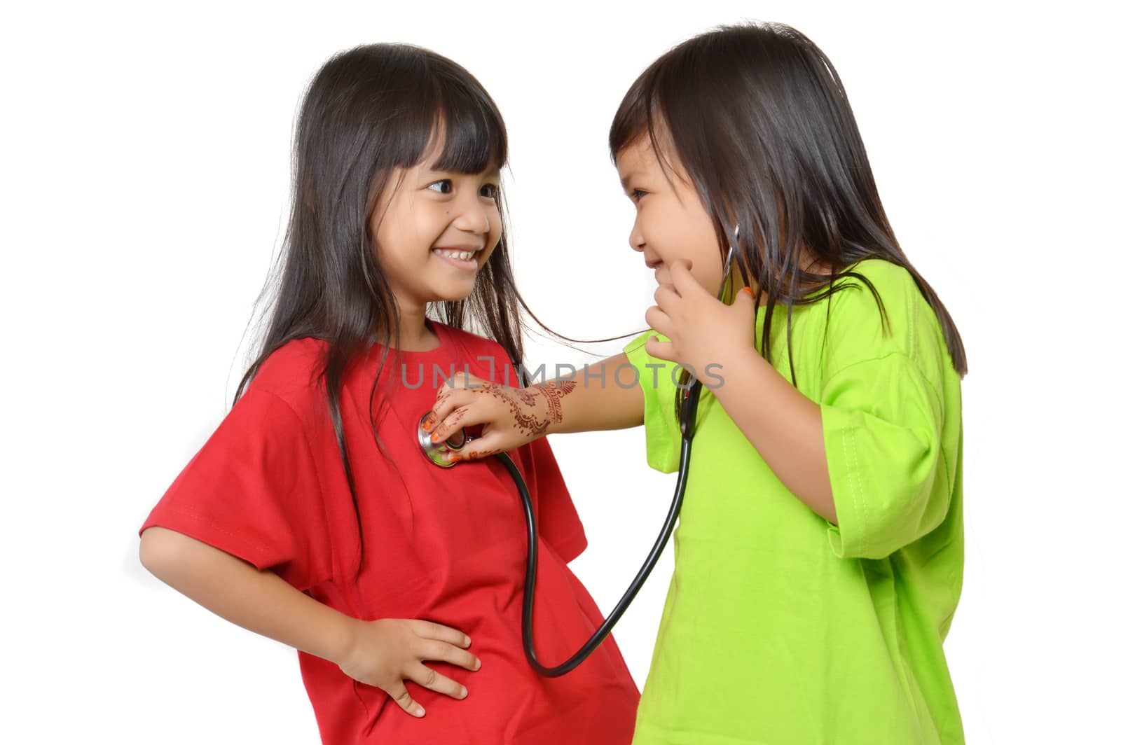 two asian little girl playing with a stethoscope