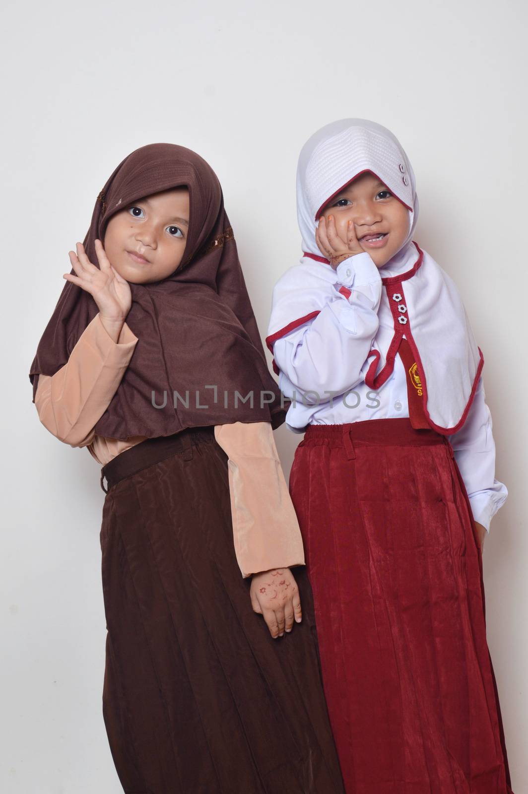 two asian little girl with primary school uniform and girl scout uniform