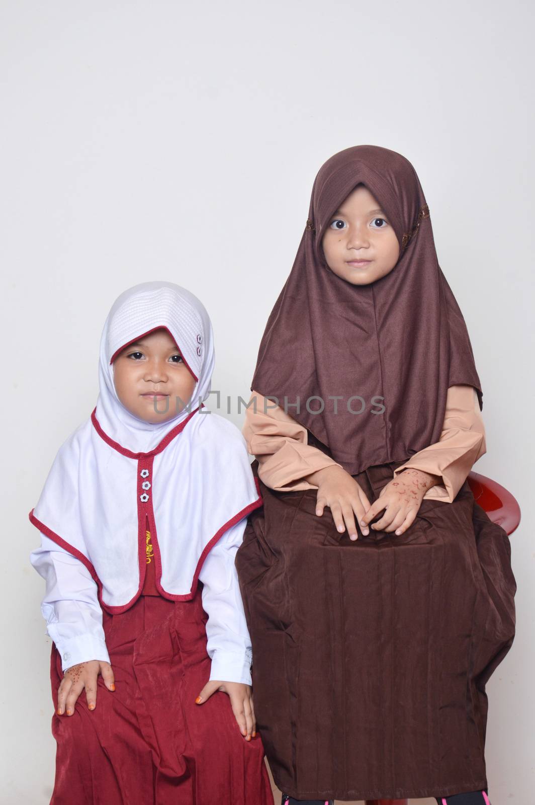 two asian little girl with primary school uniform and girl scout uniform