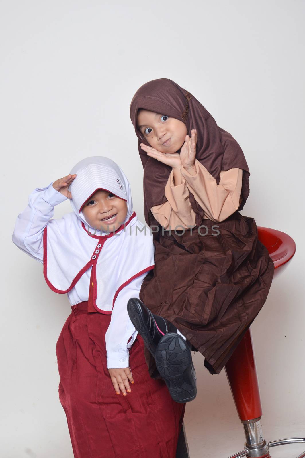 two asian little girl with primary school uniform and girl scout uniform