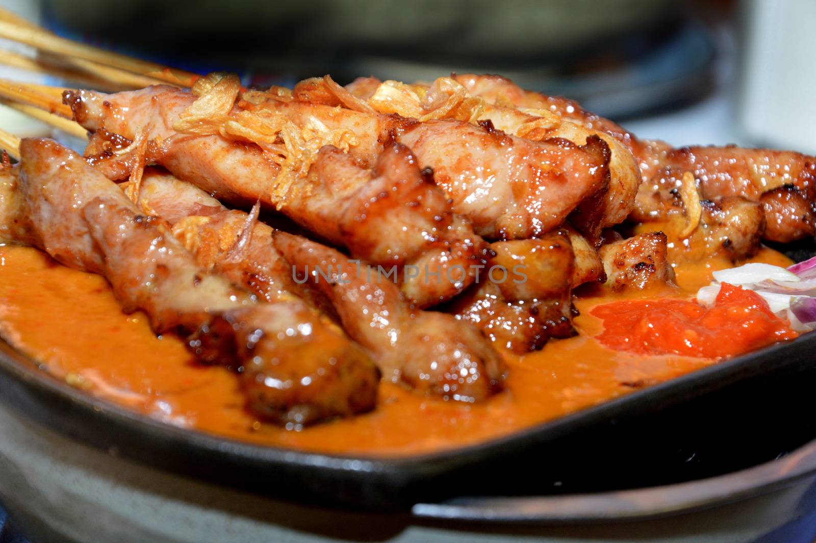 row of satay on the hot plate