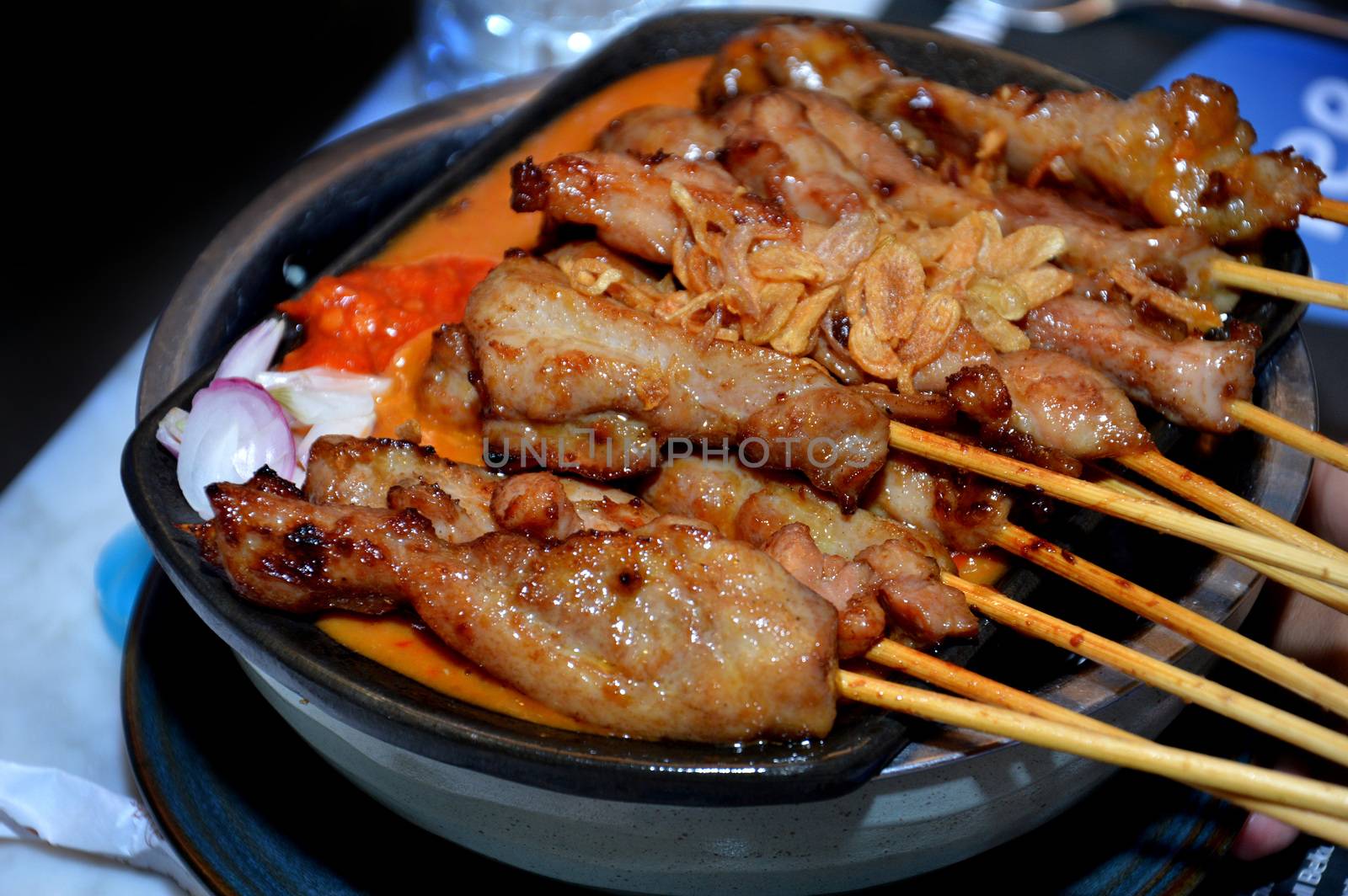 row of satay on the hot plate
