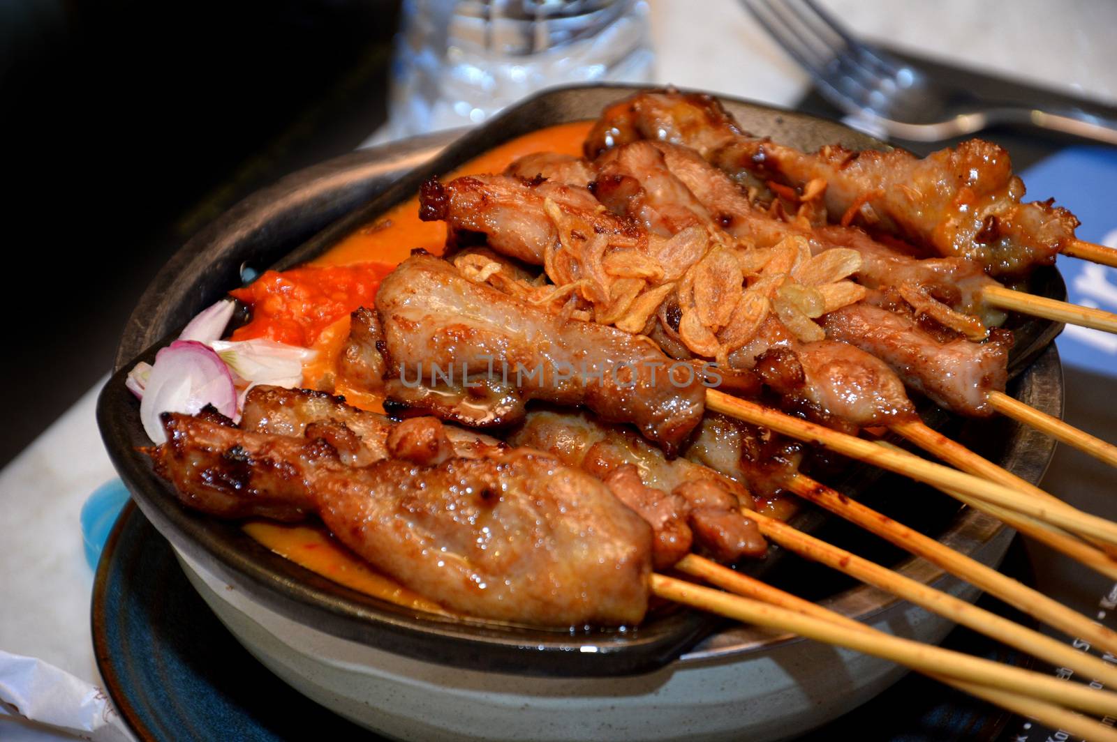 row of satay on the hot plate