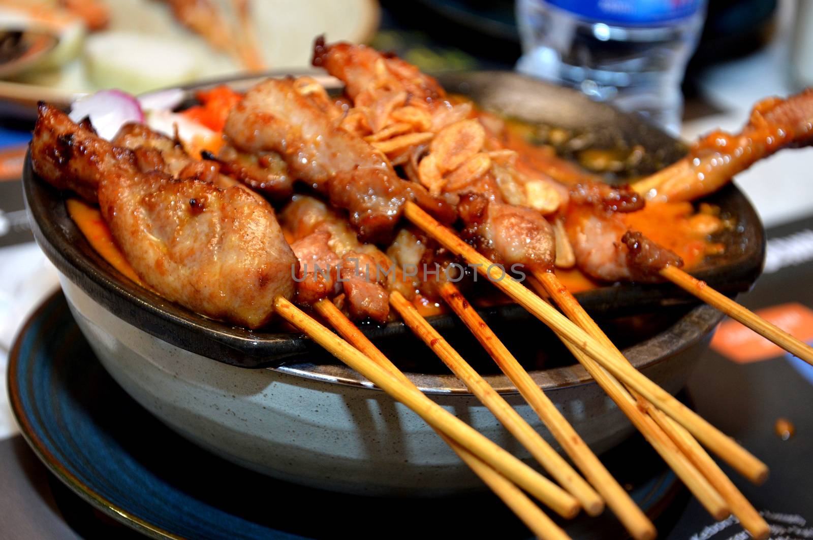 row of satay on the hot plate