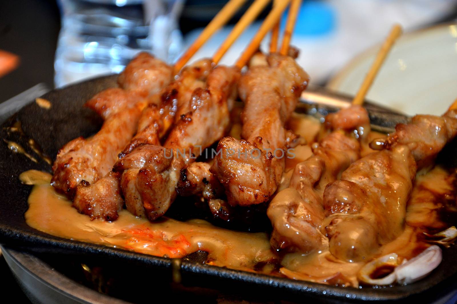 row of satay on the hot plate