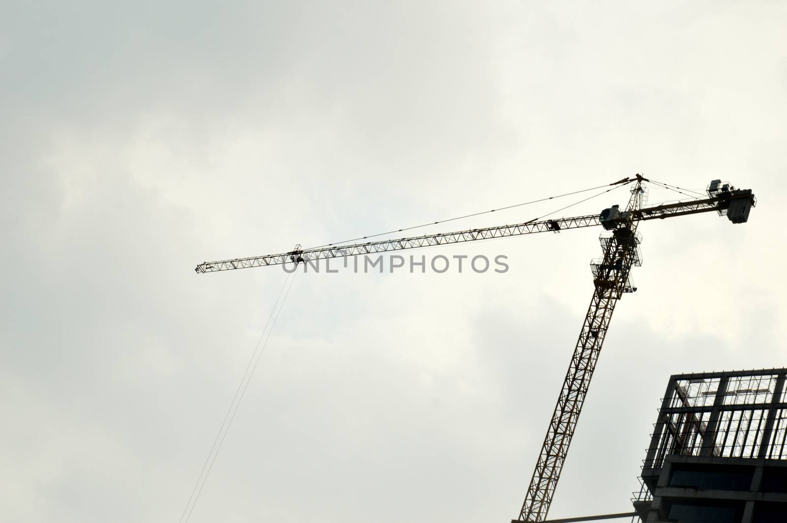 crane on a building in construction over blue sky