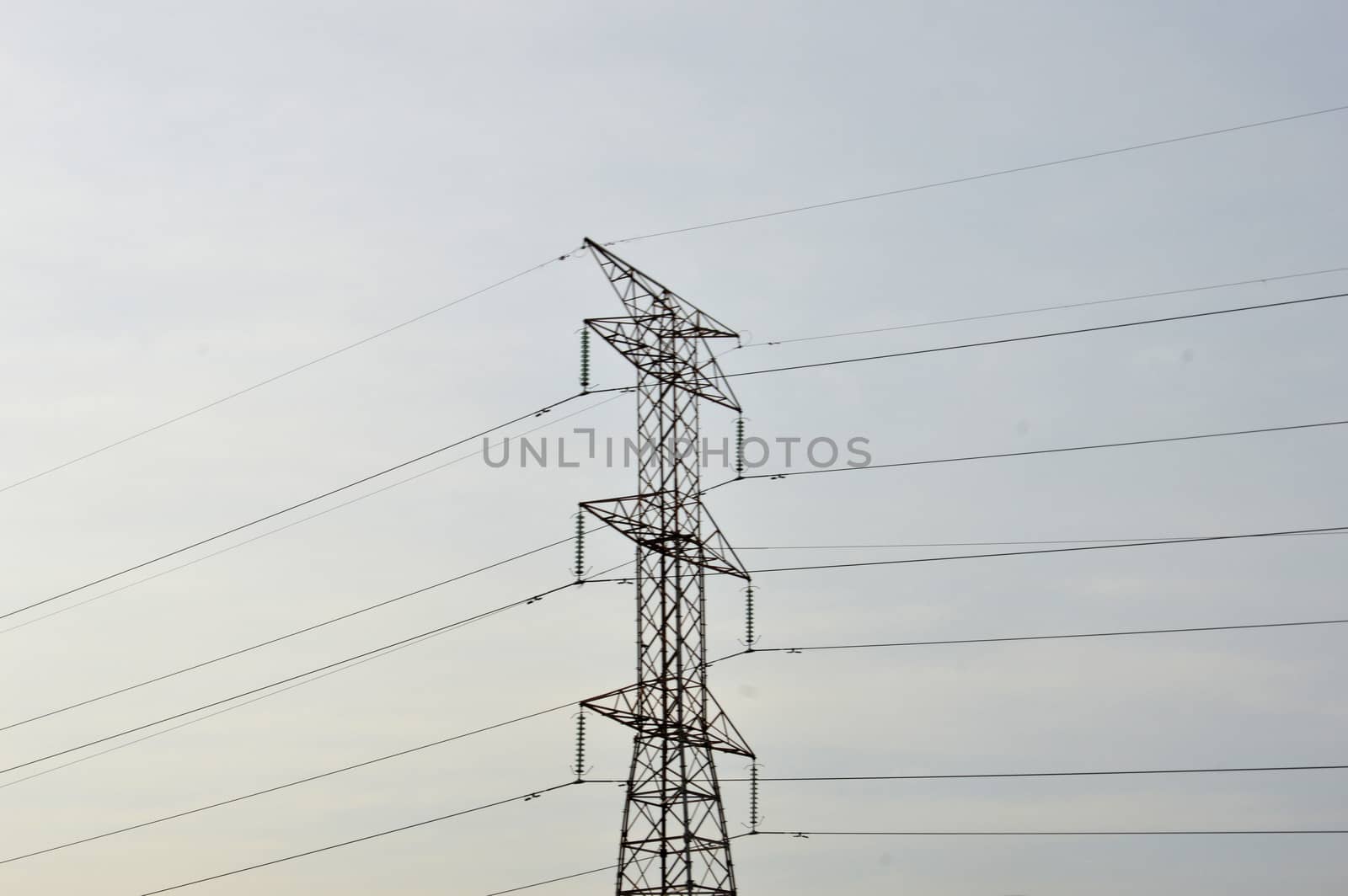 electricity poles against blue sky