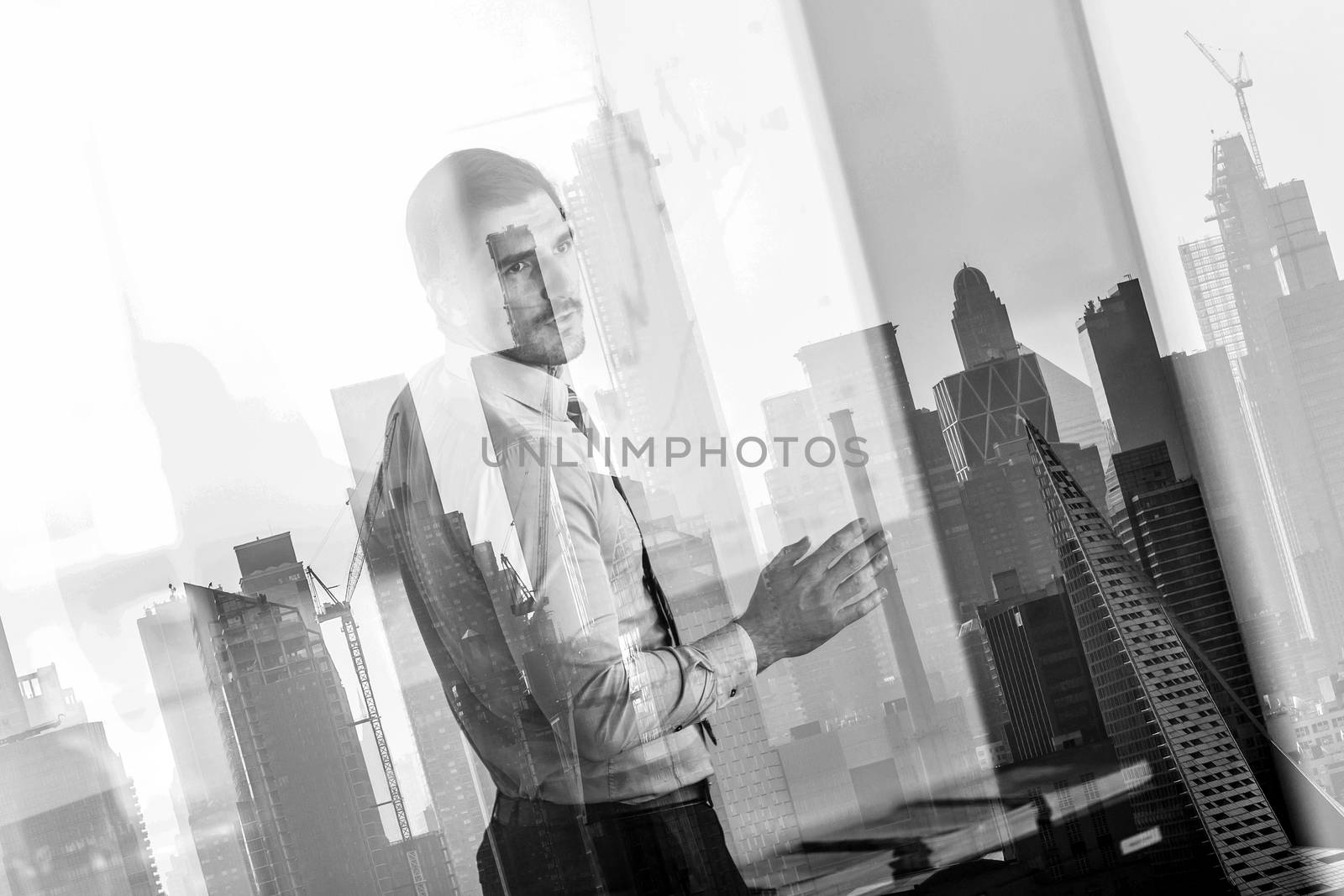 Business man making presentation in corporate office. Business executive delivering a presentation during business meeting against new york city manhattan buildings and skyscrapers window reflection.