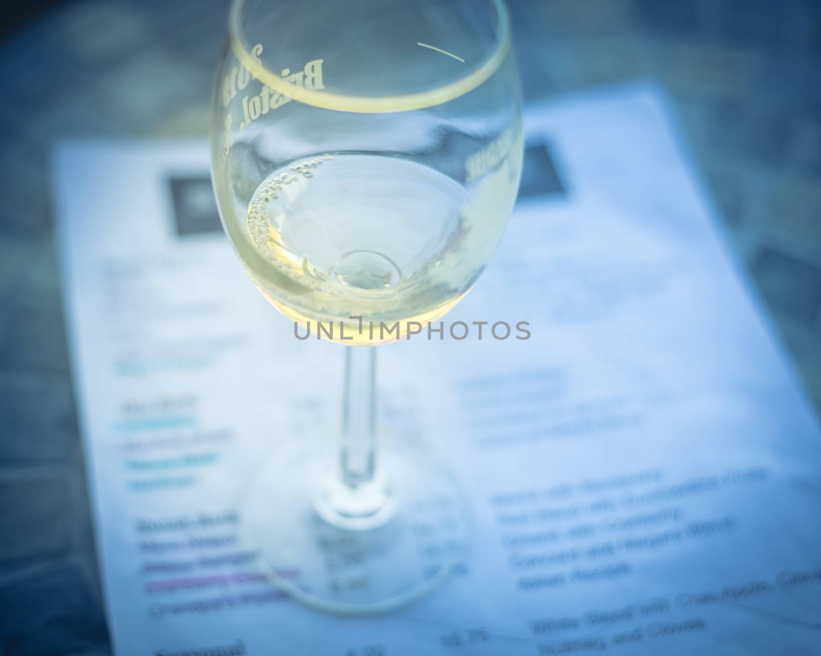 Close-up a glass of sweet white wine and tasting menu with price at local winery in North Texas, America