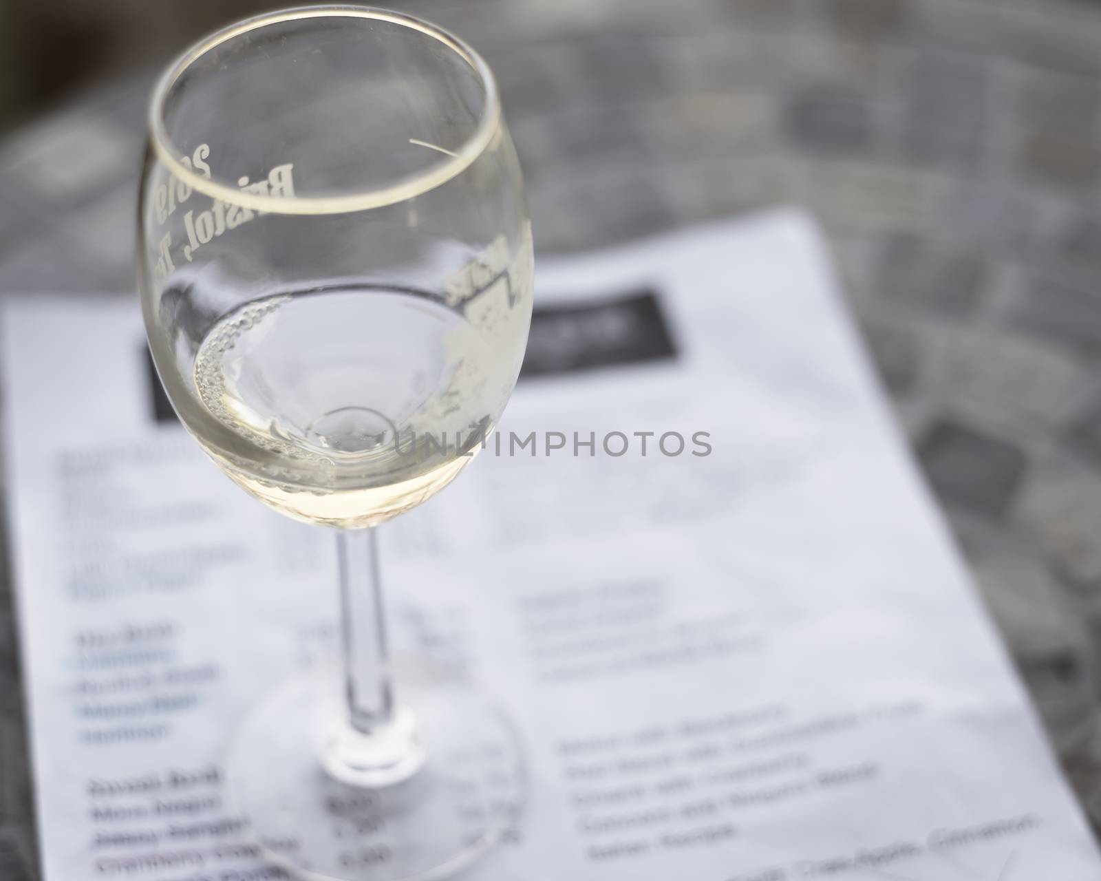 Vintage tone top view a glass of sweet white wine and tasting menu with price at local winery in North Texas, America