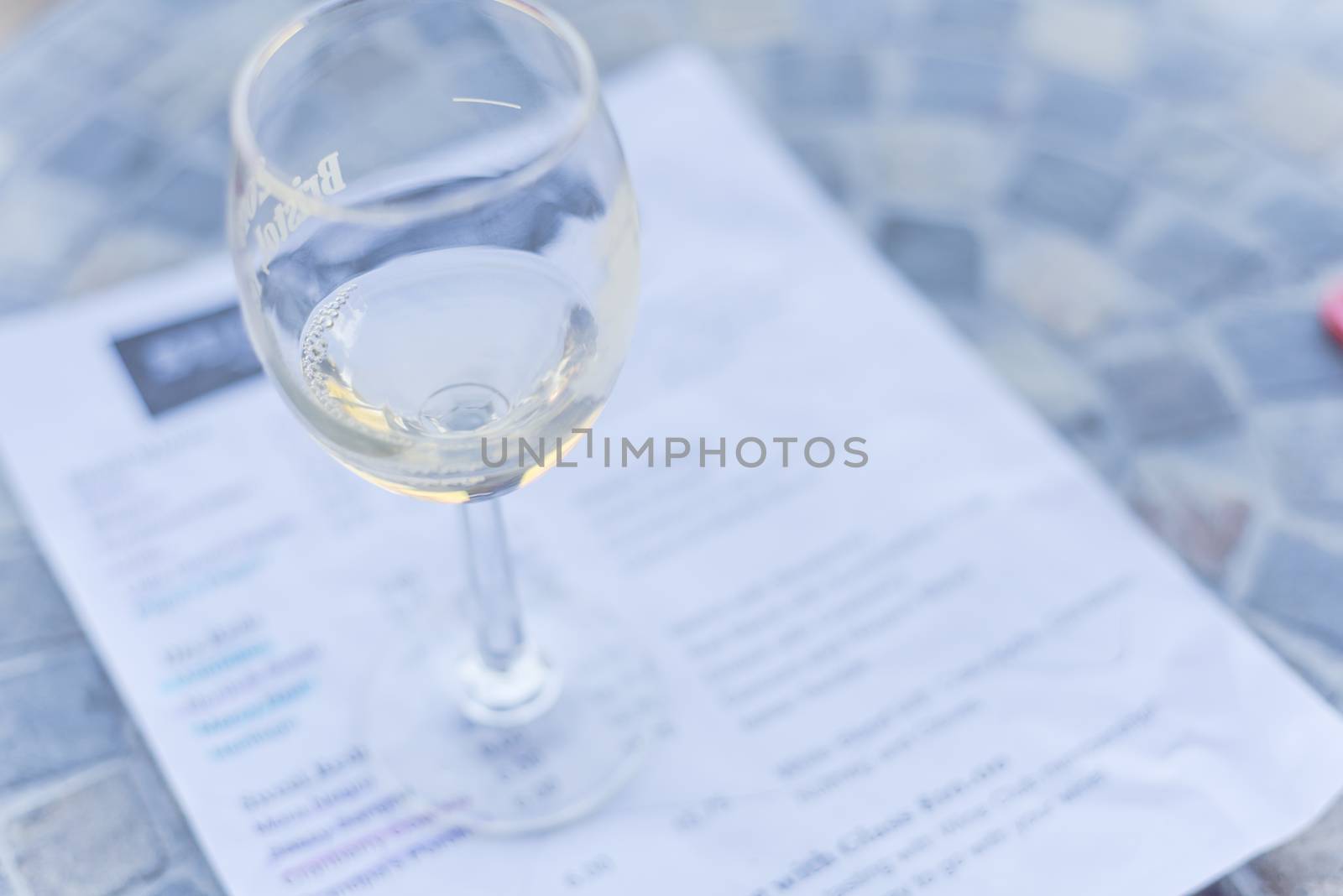 Close-up a glass of sweet white wine and tasting menu with price at local winery in North Texas, America