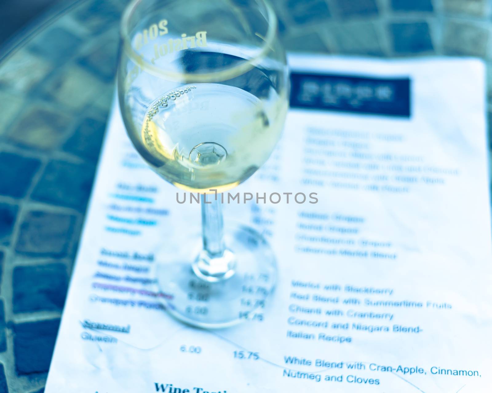 Vintage tone top view a glass of sweet white wine and tasting menu with price at local winery in North Texas, America