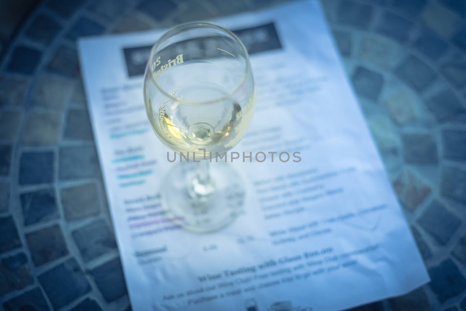 Close-up a glass of sweet white wine and tasting menu with price at local winery in North Texas, America