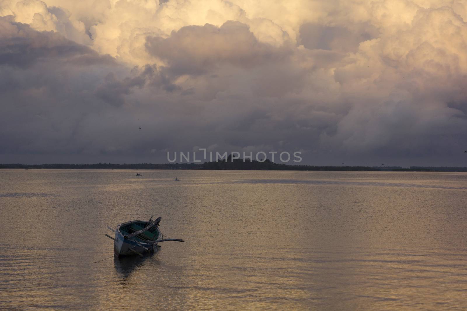 small wooden fisherman boat at the sea