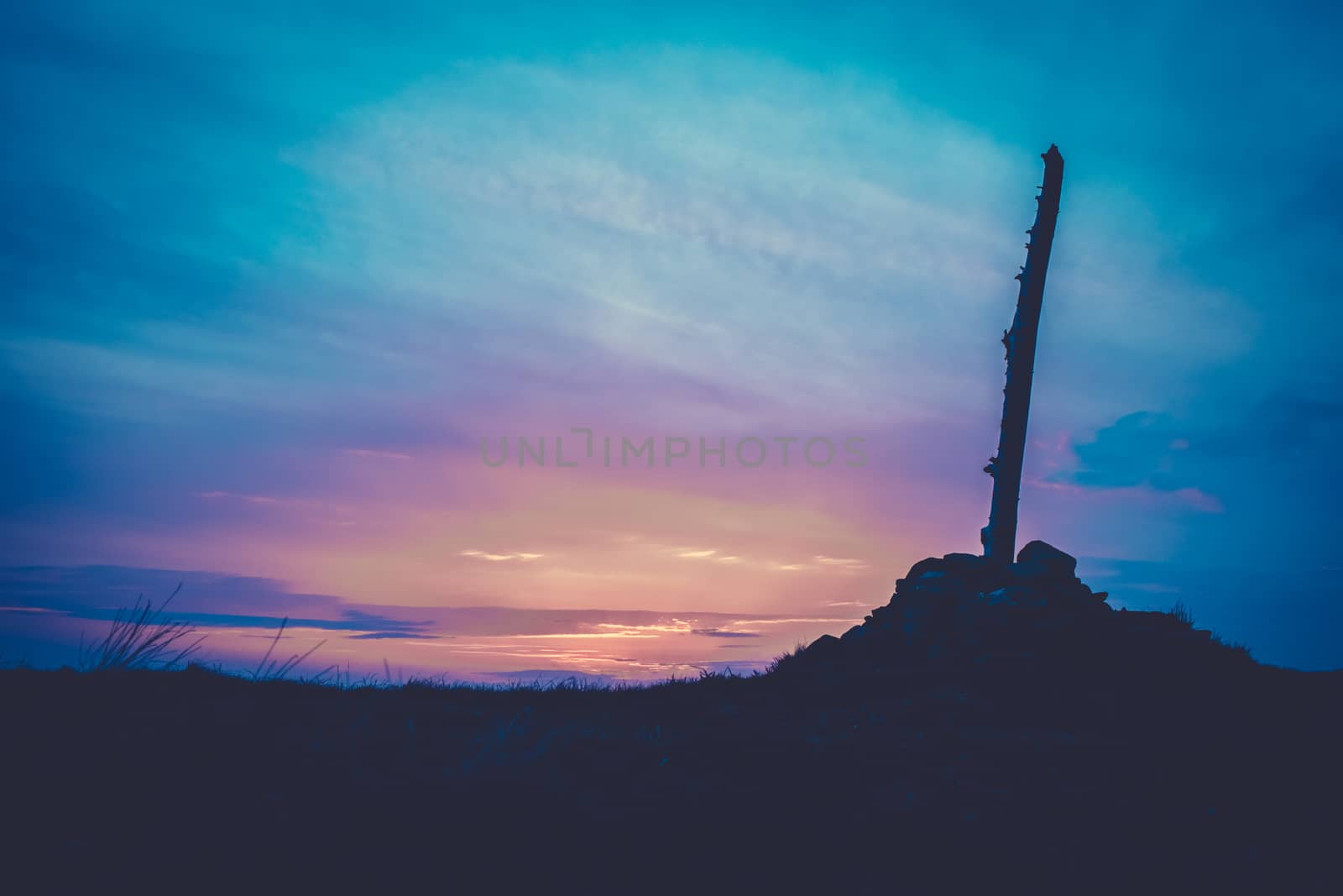 Beautiful Cairn (Pile of Stones Marking a Mountain Top) At Sunset In Scotland With Copy Space