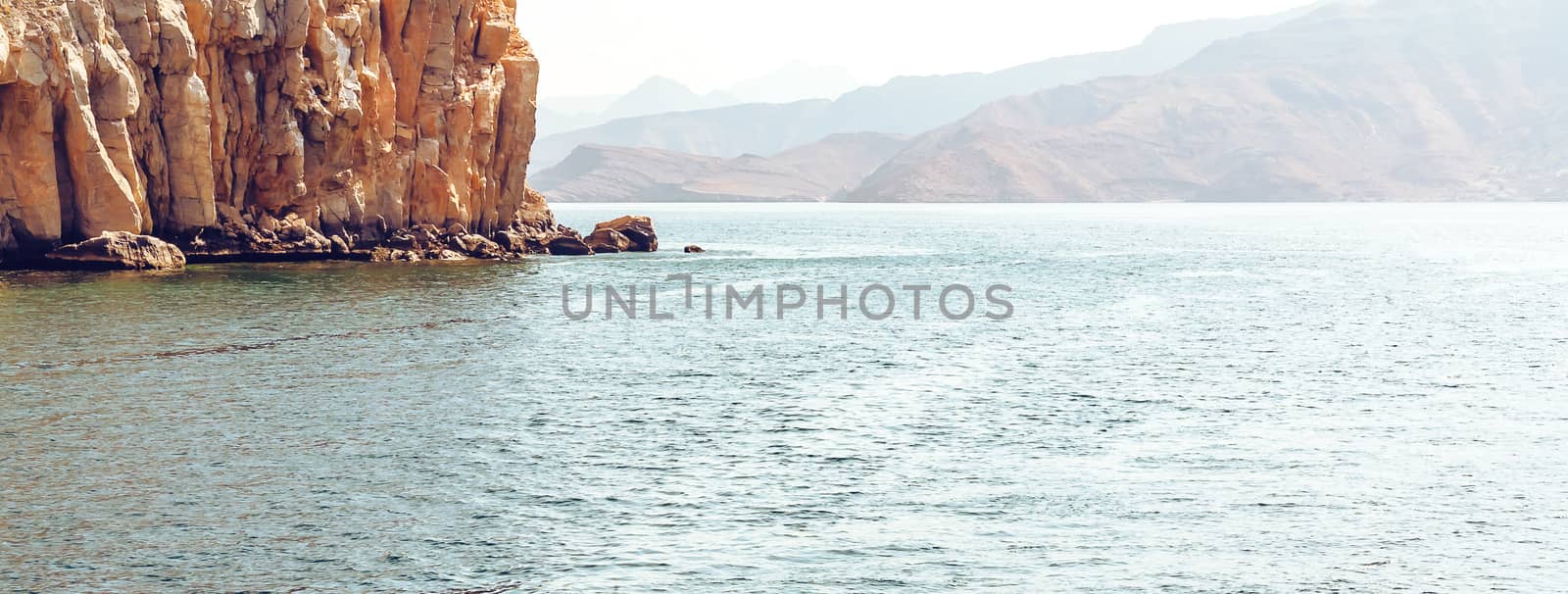 Sea and rocky shores in the fjords of the Gulf of Oman, panoramic view.