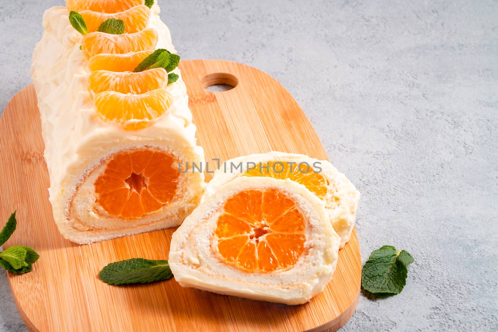 Sweet cake roll with whipped cream and tangerine filling by galsand