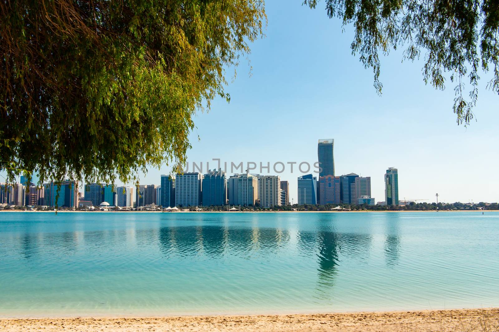 View of modern buildings from the canal shore in Abu Dhabi by galsand