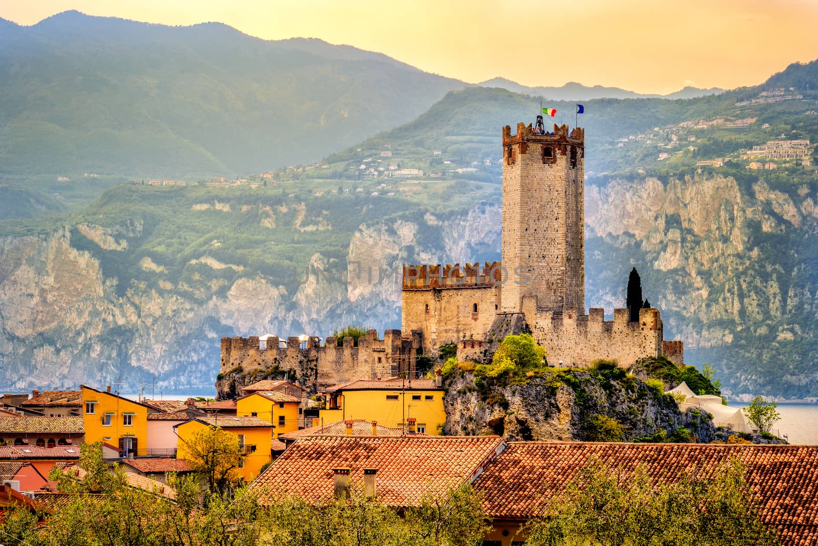 italian village malcesine peaceful town and castle on Garda Lake waterfront romantic idyllic picturesque sunset .