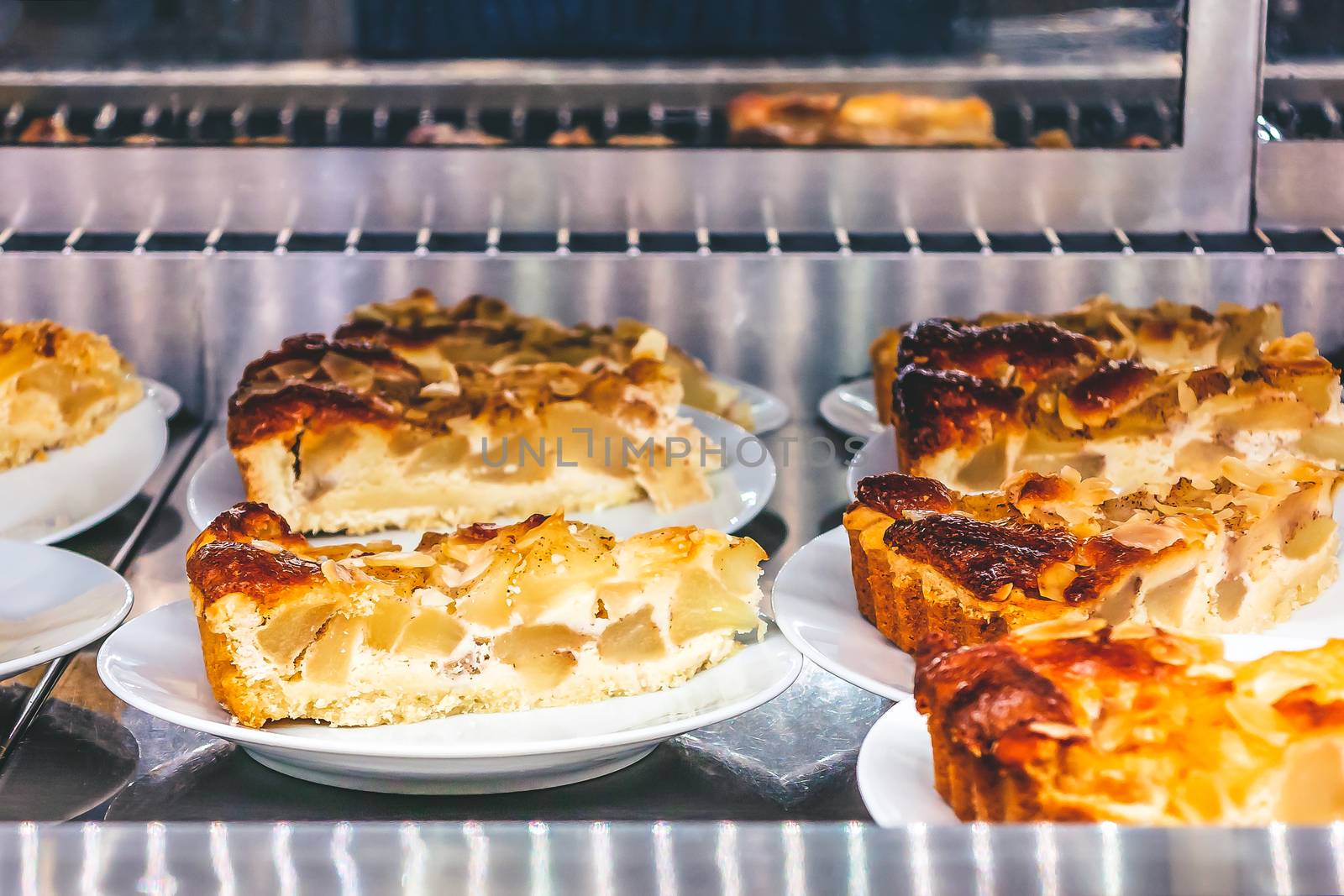 Slices of apple pie lined for sale in a cafe.