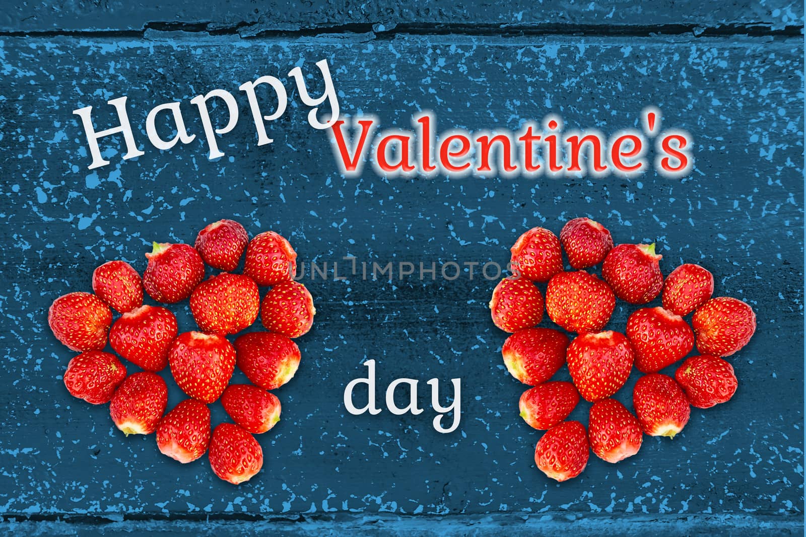 Beautiful greeting card with Valentines Day - hearts made from strawberries on the background of grunge wooden texture and the inscription Happy Valentine's Day