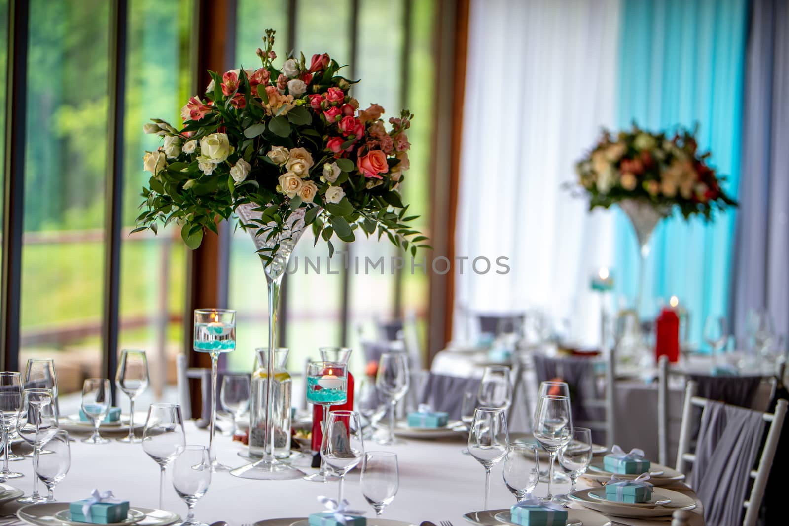 Bouquet of flowers and glasses on the wedding table by fotorobs