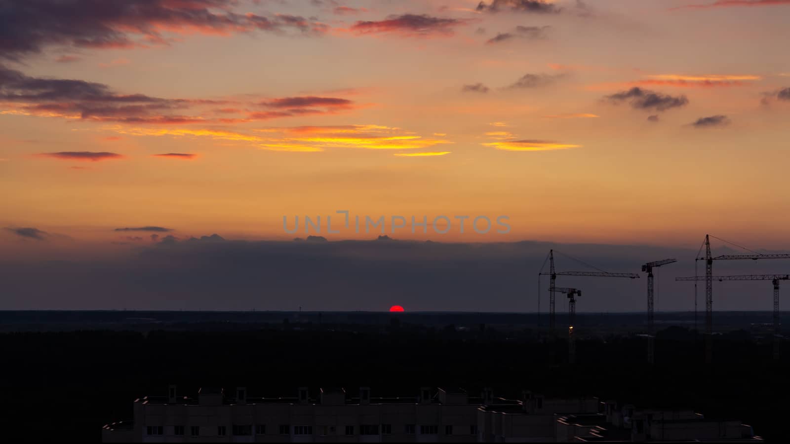 Panoramic view of the horizon and colorful sunset on the outskirts of the city.