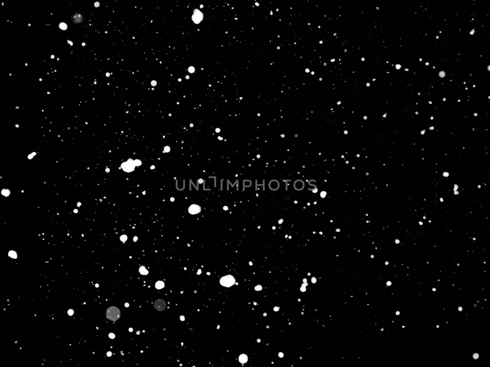 Texture of snow isolated on black background.