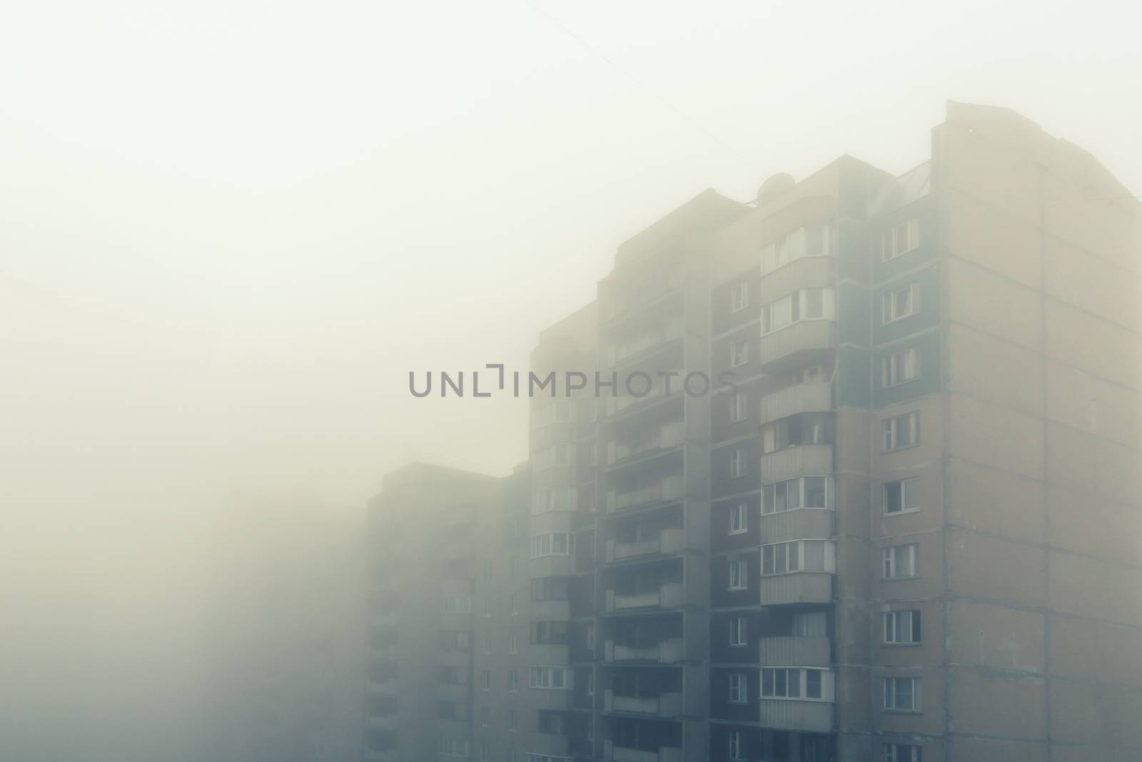 Heavy morning fog and evaporation in the city with high-rise buildings.