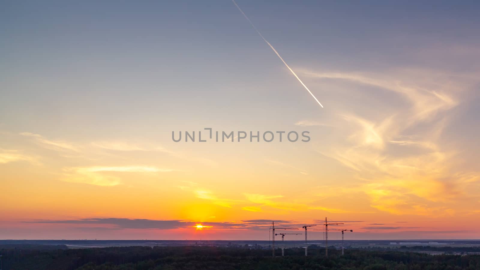 Panoramic view of the horizon and colorful sunset on the outskirts of the city.