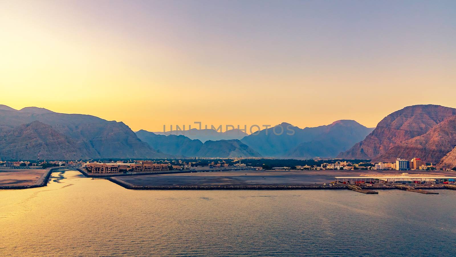 Sea coast of the Gulf of Oman, a small settlement or a town away on the shore.