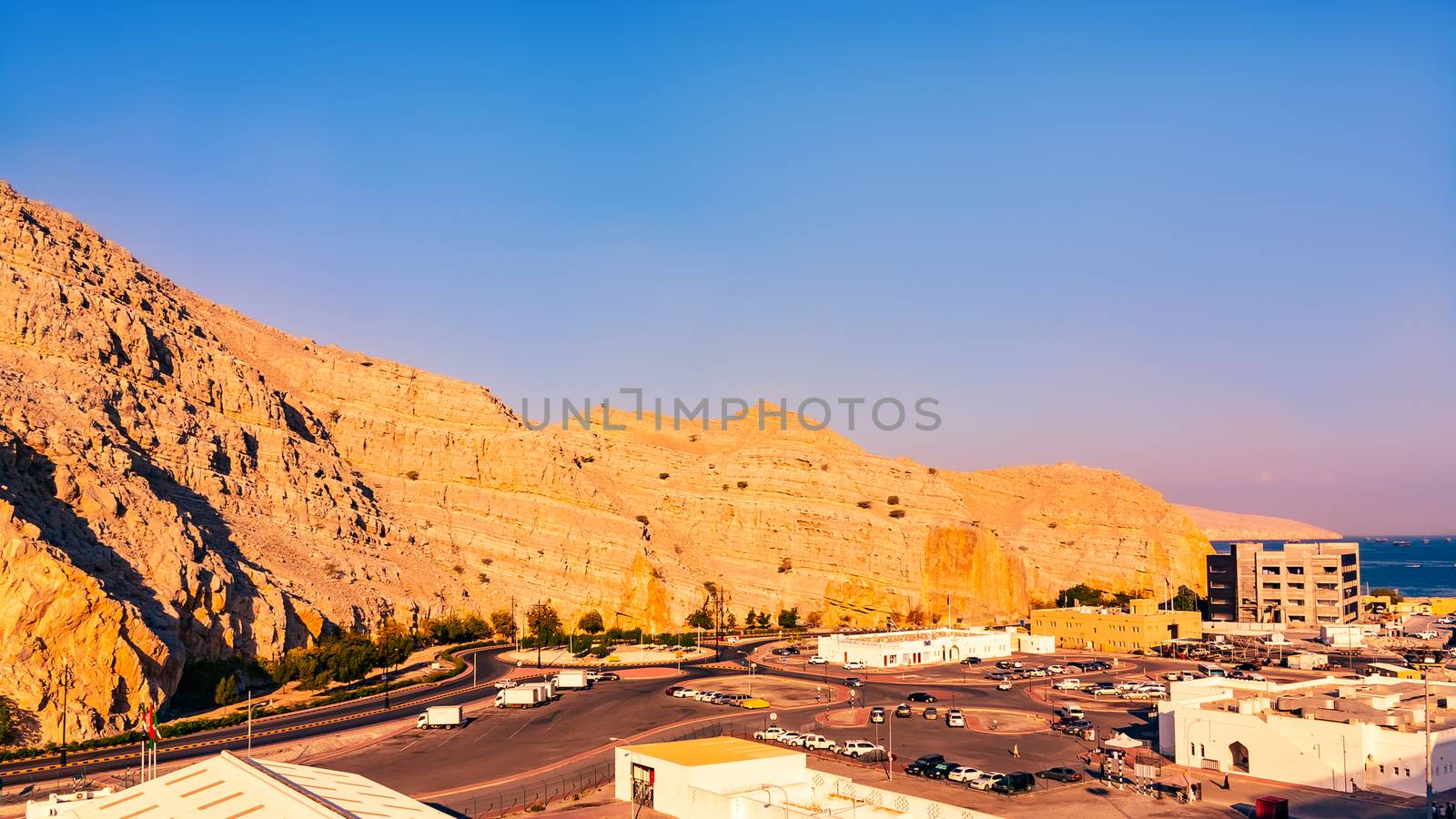 Sea coast of the Gulf of Oman, a small settlement or town on the shore by galsand