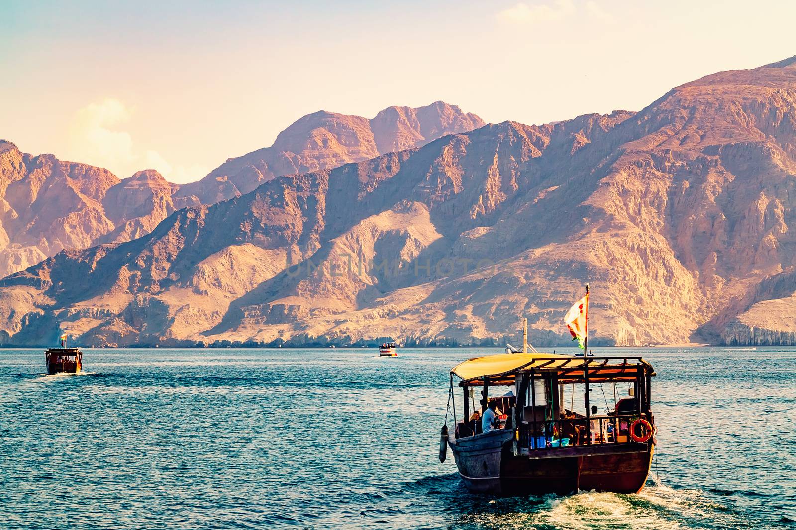 Sea, pleasure boats, rocky shores in the fjords of the Gulf of Oman by galsand