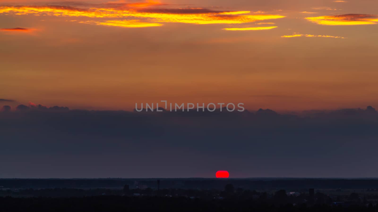 Panoramic view of the horizon and colorful sunset on the outskirts of the city.