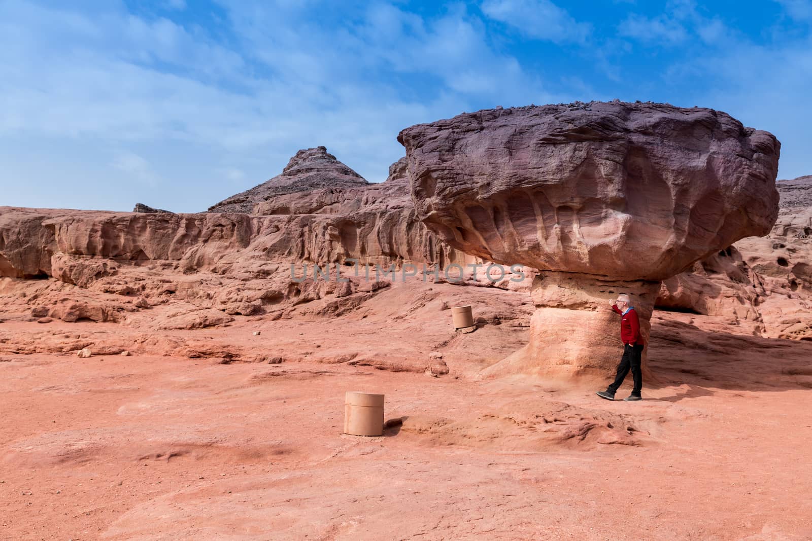 man at the famous mushroom rock in timna national park in israel, near eilat