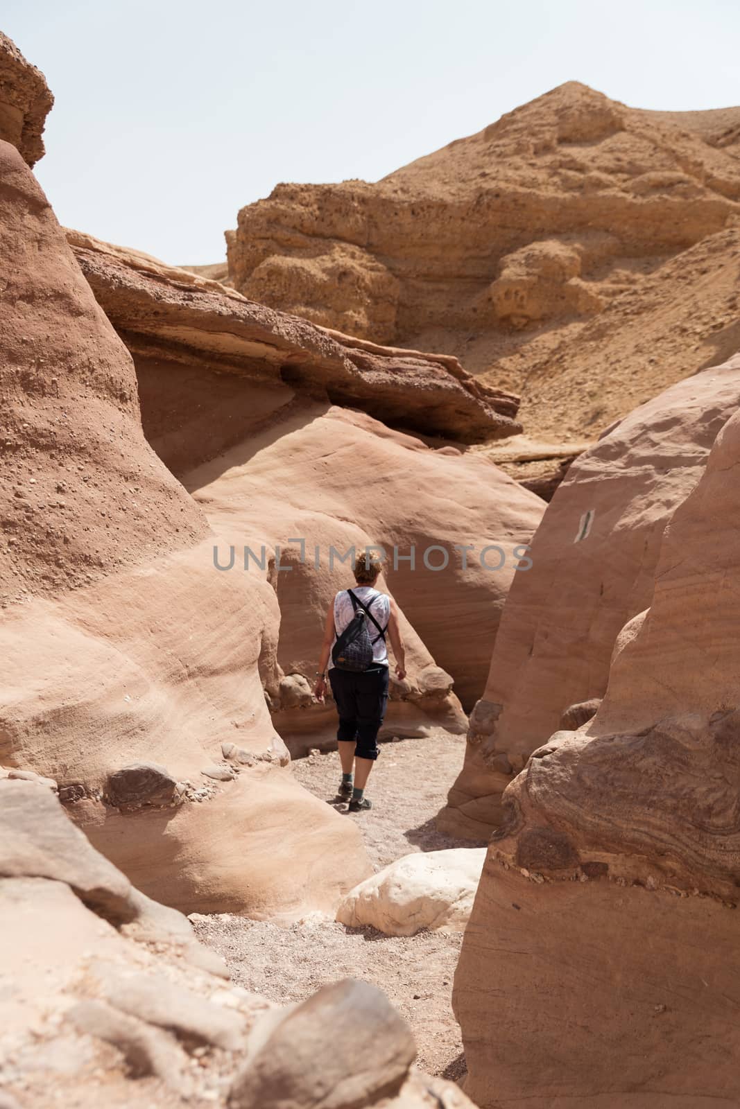 woman walking in the red canyon in israel